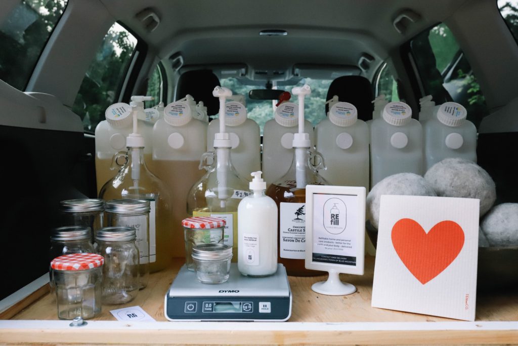The back of a car with bottles, jars, and a heart.