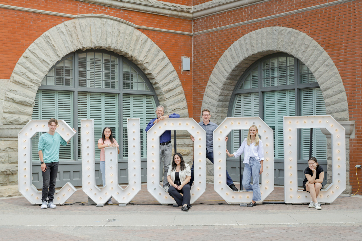 A group of participants posing in front of a large letters.