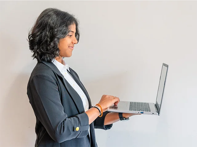 Samindra holding a laptop